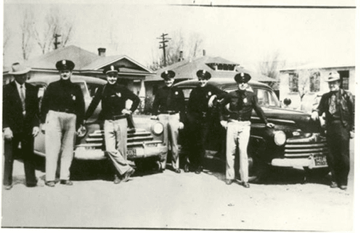 Historical - Officers standing with patrol cars