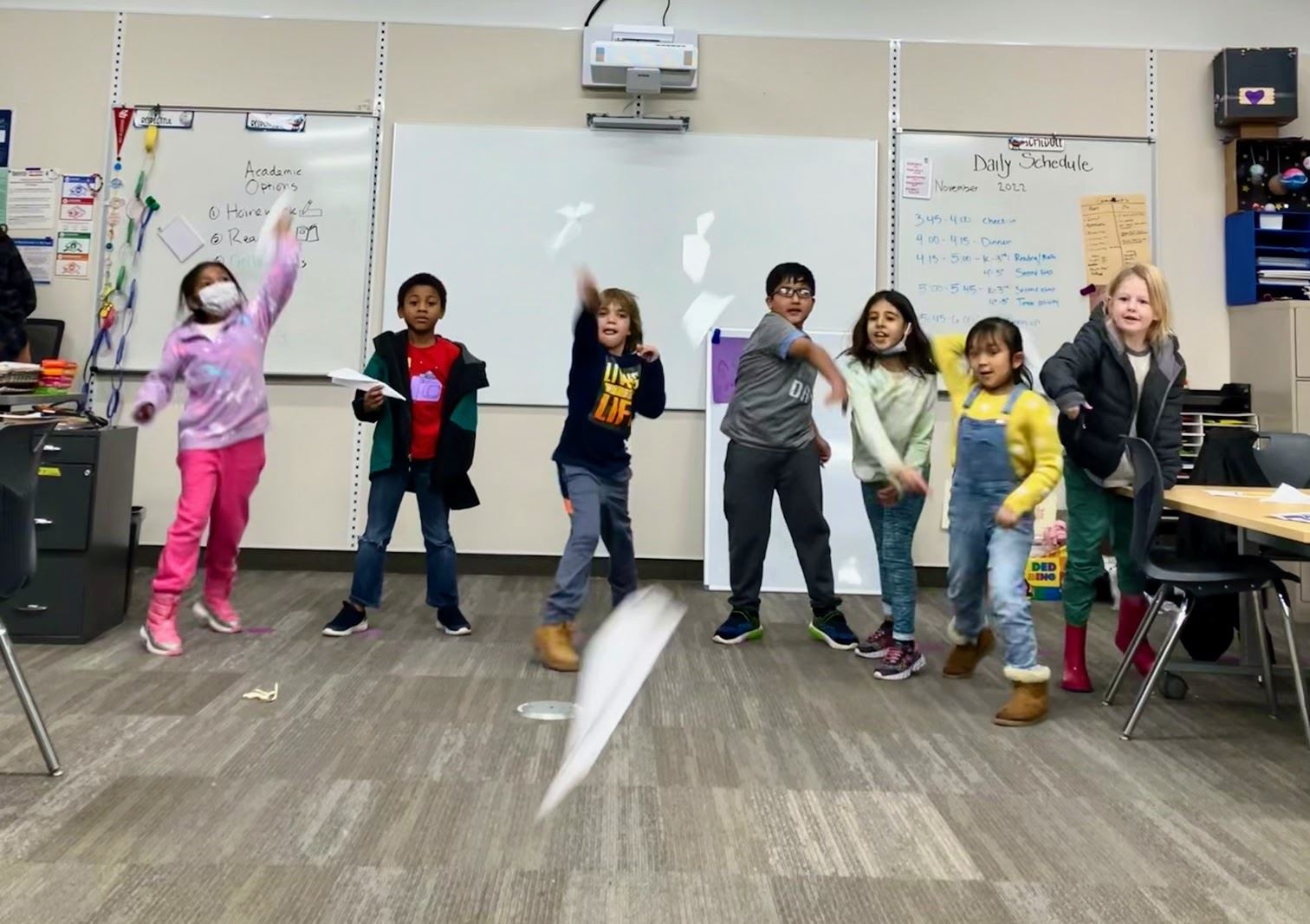 Children throwing paper airplanes