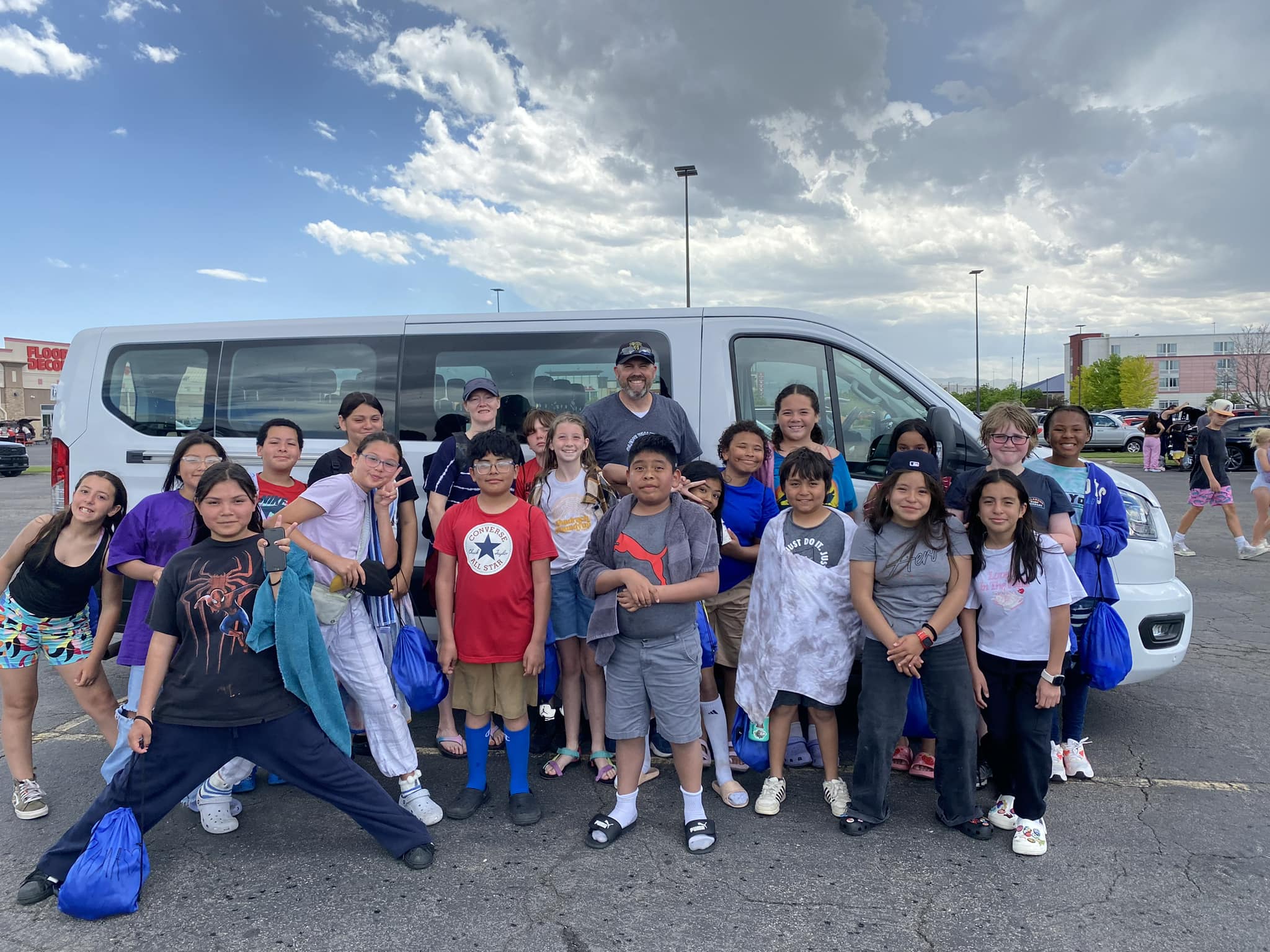 officers with group of kids in front of van